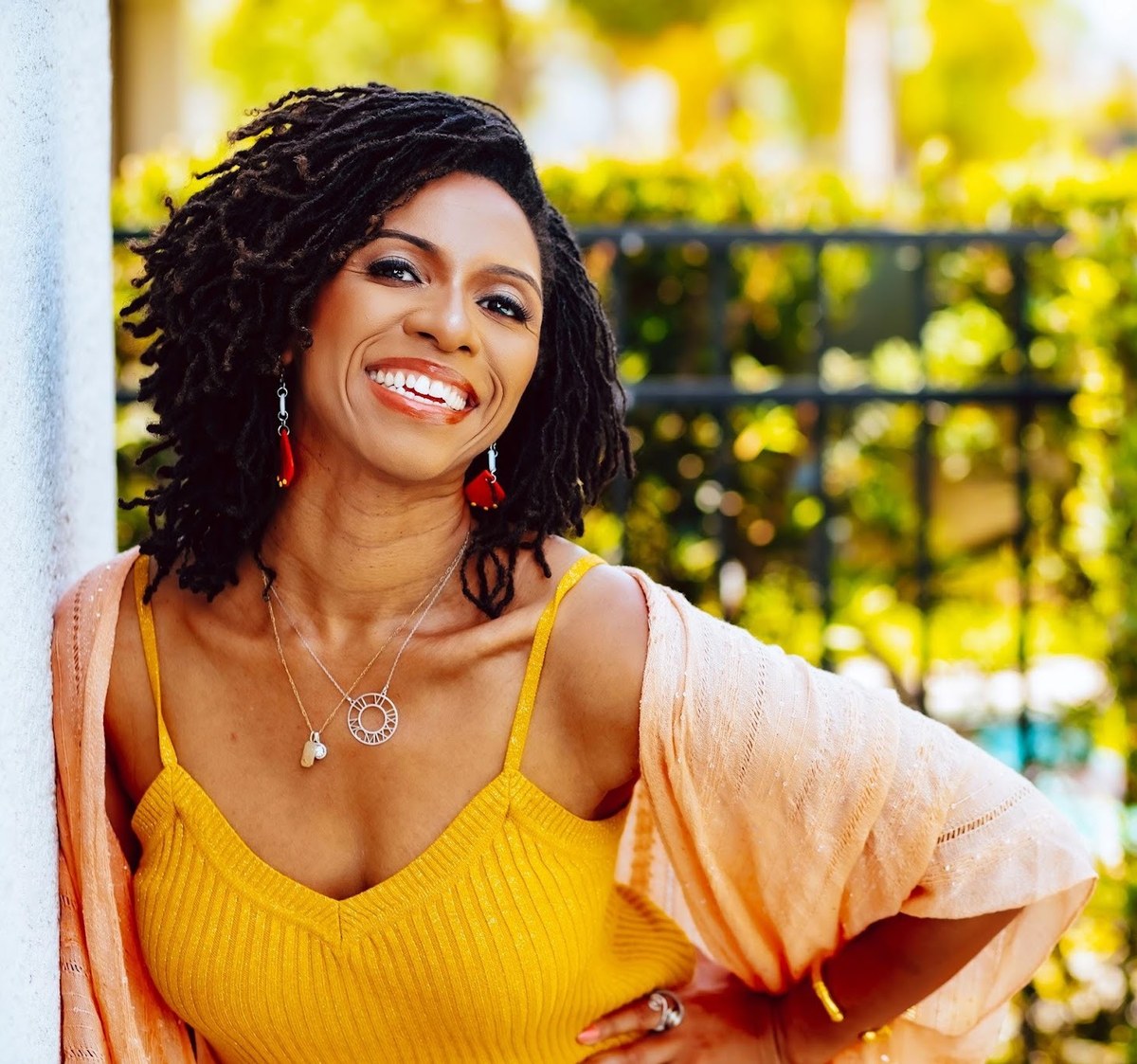 Nuria McGrath smiling in a garden